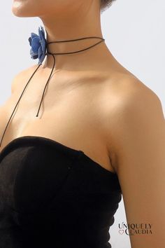 Introduce fun styling to your wardrobe with the Denim Rose & Vegan Leather Choker. Its combination of medium-wash denim rose and luxe vegan leather lends a sophisticated touch to any ensemble, while the versatile design allows you to wear it as a choker or a waist belt. 3" Circumference Satin Rose 60" Long Suede Cord Trendy Spring Choker, Chic Spring Party Choker, Trendy Adjustable Choker For Spring, Chic Adjustable Choker For Summer, Chic Summer Party Choker, Chic Adjustable Summer Choker, Adjustable Leather Trendy Choker, Denim Choker, Satin Roses