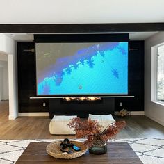 a flat screen tv mounted to the wall in a living room