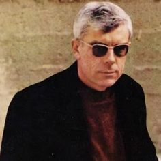 an older man with white hair wearing sunglasses