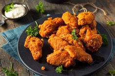 fried chicken on a black plate with parsley