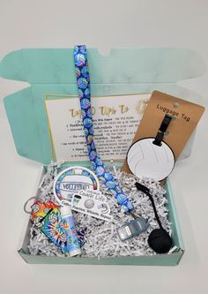 an open box filled with items like a lanyard, headphones and other accessories