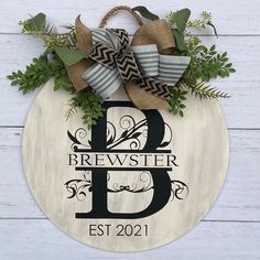 a wooden sign that says, bewerter b est 2021 on it with some greenery