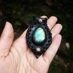 Immerse yourself in the enchanting energies of this Labradorite talisman. Encased in black leather, it radiates a mystical light, offering protection and enhancing your spiritual insight. The talisman comes with an optional leather cord, providing a choice between the natural feel of leather and the pendant alone. Size of the pendant - approx. 3.6cmx7.7cm Uses -Ideal for daily wear to harness the labradorite's intuitive and spiritual energies. -Perfect for meditation or spiritual practices to en Leather Jewelry With Natural Stones For Gift, Handmade Black Necklace For Larp, Handmade Black Leather Necklace, Leather Pendant Jewelry For Gifts, Handmade Black Leather Jewelry, Unique Hand Tooled Black Jewelry, Black Hand-tooled Bohemian Jewelry, Black Hand Tooled Bohemian Jewelry, Unique Black Jewelry For Everyday Use