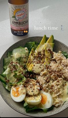 a plate full of food next to a bottle of kombucha