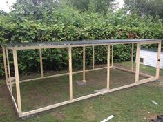 a chicken coop in the middle of a yard