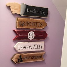 there are five wooden signs on the wall