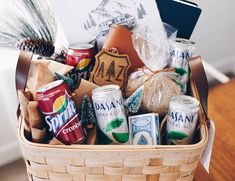 a basket filled with beer and snacks on top of a wooden table