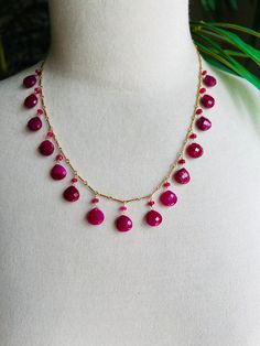 18 1/2" (plus 2" extender) necklace featuring hand wire wrapped ruby briolettes/drops and ruby rondelles.  The rubies are dyed to a nice bright dove's blood color. There are 4mm faceted rondelles and the briolettes/drops are faceted and measure approximately 10x10mm.  There are 15 rubies which are hand wire wrapped 3/4" apart from each other on chain.  Each drop has a rondelle on top of it.  All the chain, wire and lobster claw clasp are 14k gold filled.  This bright colorful necklace is a real Red Briolette Necklace With Faceted Beads, Red Briolette Gemstone Beads Necklace, Drops Necklace, Colorful Necklace, Colourful Necklace, Drop Necklace, Necklace Designs, Lobster Claw, Wire Wrapped