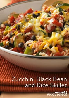 zucchini black bean and rice skillet in a white bowl on an orange towel