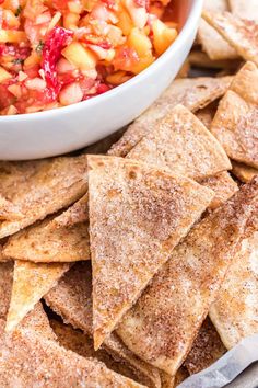 a white bowl filled with fruit salsa next to tortilla chips