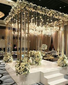 an elegant wedding setup with flowers and chandeliers