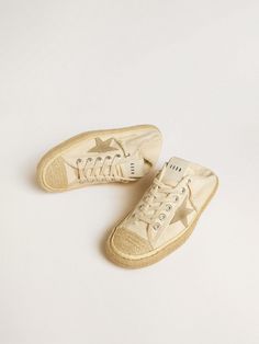 Driven by the essence of sun-drenched days by the sea, the Resort Collection captures the retro-inspired vibrance of summer spent in lustful oasis lustful that breathes carefreeness into each garment. These women's V-Star Sabots in cream canvas feature a toe and foxing in raffia and a beige suede star. Goose Sneakers, Golden Goose Sneakers, Lace Socks, Clothes For Men, Resort Collection, New Journey, Bag Handle, Golden Goose, By The Sea