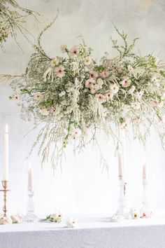 the table is set with flowers and candles