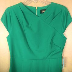 Women’s Dress, Size 10, Short Sleeves, V Neck, Wrap Look At Top Of Dress, Green, Exposed Gold Zipper In The Back, She’ll 97% Polyester 3% Spandex, Lining 97% Polyester 3% Spandex, Slight Flare At Hem, 36 Inches Shoulder To Hem, 18 Inches Pit To Pit, #1003 Green Lined Dress For Workwear, Green Lined Dresses For Work, Evening Mini Dresses, Midi Pencil Dress, Crochet Lace Dress, Velvet Midi Dress, Embroidered Midi Dress, Ruffle Midi Dress, Casual Evening