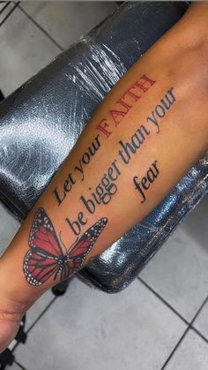 a person with a butterfly tattoo on their arm that says let your faith be bigger than you