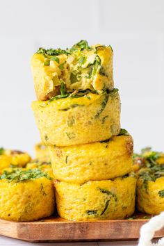 several small muffins stacked on top of each other with spinach and cheese