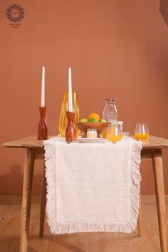 a wooden table topped with oranges and drinks