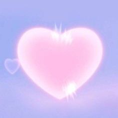 a pink heart shaped object floating in the air with clouds and blue sky behind it