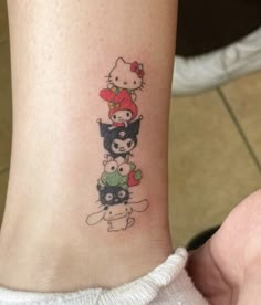 a hello kitty tattoo on the leg of a woman's right arm and foot