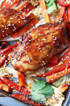 chicken with sesame seeds and carrots on a tray