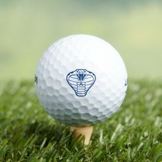 a white golf ball sitting on top of a wooden tee