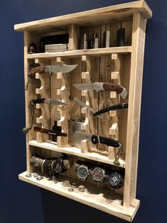 a wooden shelf with many different types of knives on it