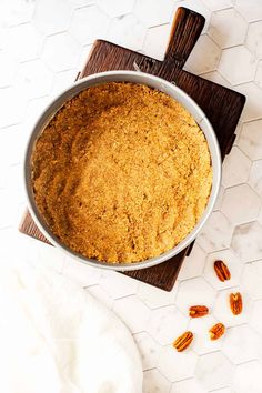 a cake in a pan with pecans on the side