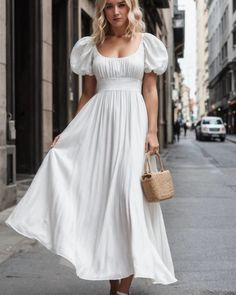 a woman in a white dress is walking down the street with her hand on her hip