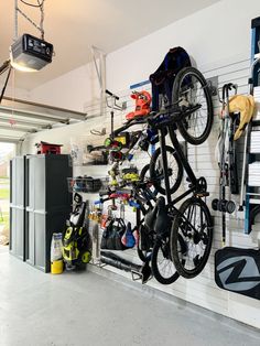 a bike hanging from the ceiling in a garage with tools and equipment on it's rack