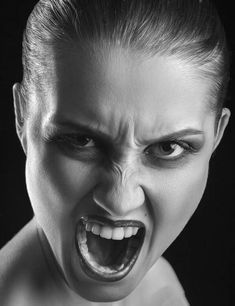 a woman with her mouth open and an evil look on her face