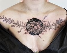 a woman with a bird's nest tattoo on her chest