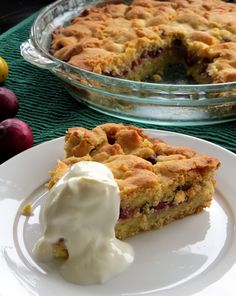 a piece of pie sitting on top of a white plate next to a bowl of fruit