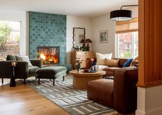 a living room filled with furniture and a fire place in the middle of the room