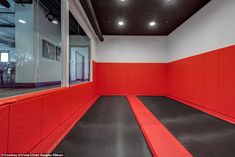 an empty room with red and black walls