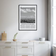 a black and white photo hanging on the side of a wall next to a dresser