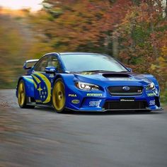 a subaru racing car driving down the road