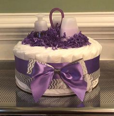 a diaper cake decorated with purple flowers and lavenders