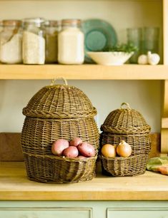 two wicker baskets sitting on top of a wooden counter next to other kitchen items