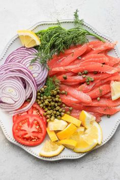 salmon, capers, onions and lemon slices on a plate