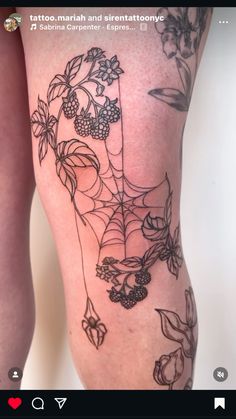 a woman's leg with tattoos on it and flowers in the middle of her legs