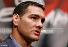 a close up of a man in a suit and tie looking off to the side