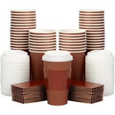 a stack of brown and white paper cups next to a pile of brown and white plates