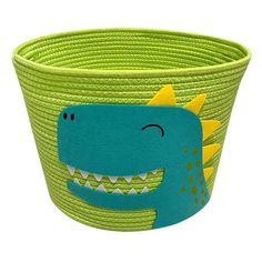 a green basket with a dinosaur design on it