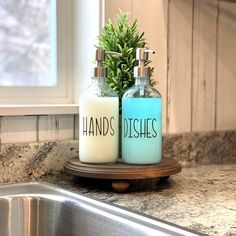 two soap dispensers sitting on top of a kitchen counter