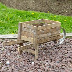 an old wooden wagon sitting on top of gravel