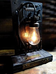 an old fashioned light bulb sitting on top of a piece of wood