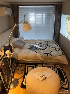 a bed room with a neatly made bed and a flat screen tv on the wall