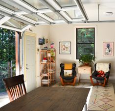 a living room filled with furniture and a wooden table