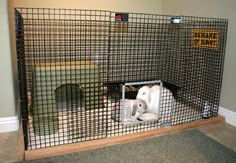 two stuffed animals in a caged area with a sign on the wall behind them