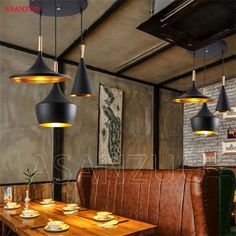 an image of a restaurant setting with wooden tables and leather booths in the center, along with modern lighting fixtures